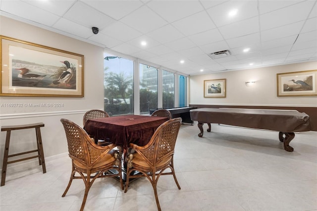 rec room with pool table, a paneled ceiling, and light tile patterned floors