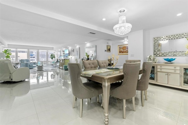 tiled dining space with an inviting chandelier