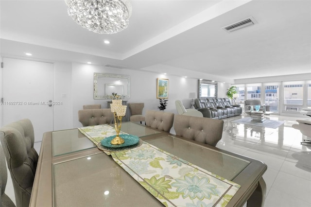 dining area with light tile patterned floors and an inviting chandelier