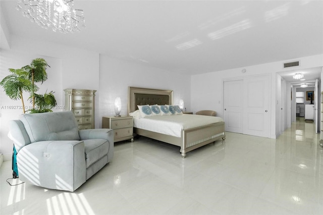 bedroom with an inviting chandelier and light tile patterned floors