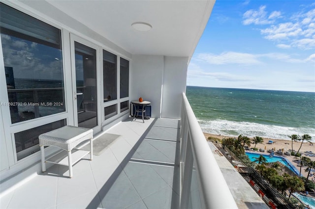 balcony featuring a water view and a view of the beach