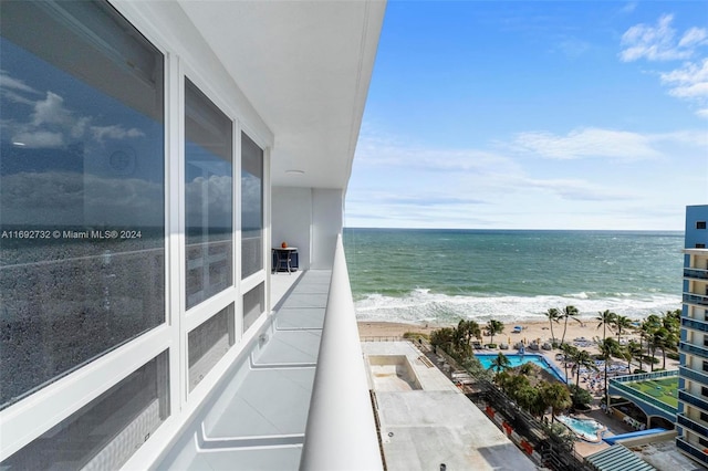 balcony with a view of the beach and a water view