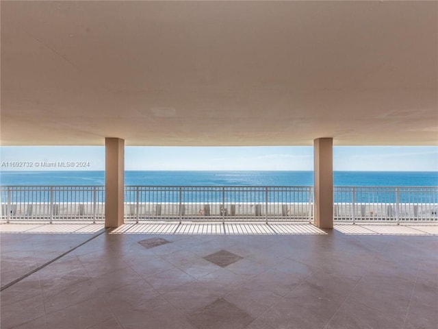 view of patio featuring a view of the beach and a water view