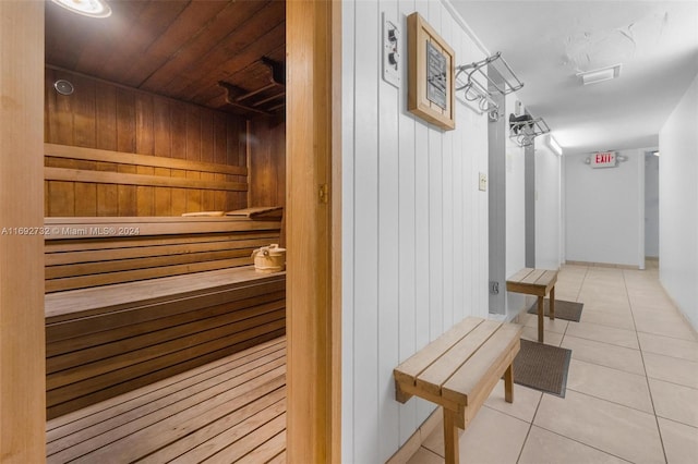 view of sauna featuring wood walls, tile patterned floors, and wooden ceiling