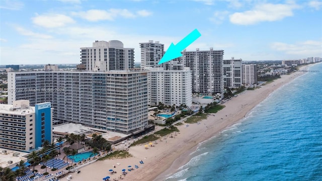 birds eye view of property featuring a view of the beach and a water view