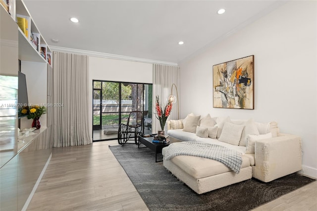 living room with wood-type flooring and ornamental molding