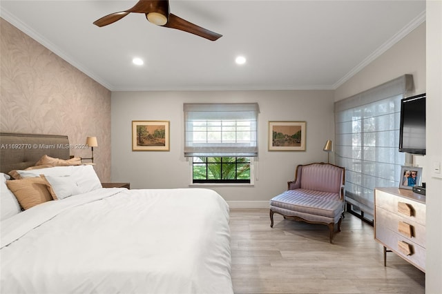 bedroom with light hardwood / wood-style floors, ceiling fan, and crown molding