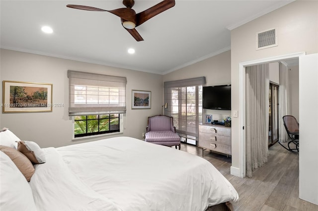 bedroom featuring hardwood / wood-style flooring, ceiling fan, lofted ceiling, and ornamental molding