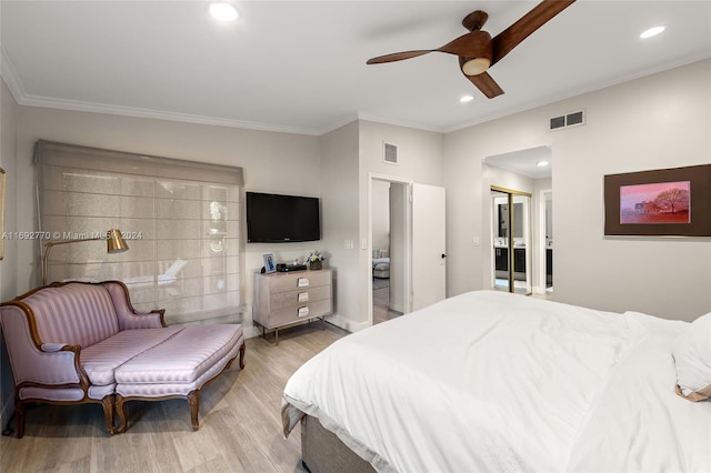 bedroom featuring ceiling fan, a closet, light hardwood / wood-style flooring, and ornamental molding