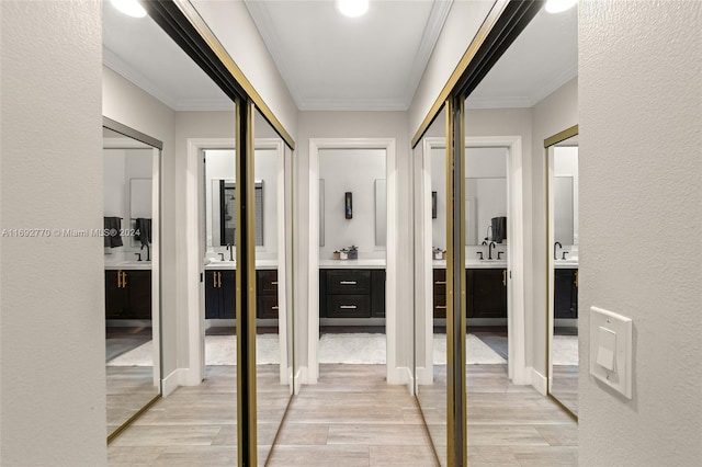 corridor with sink, light hardwood / wood-style flooring, and crown molding