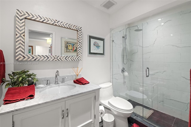 bathroom featuring walk in shower, vanity, and toilet