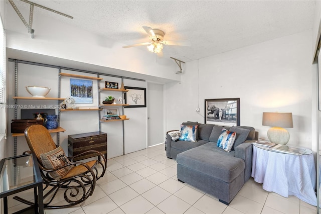 living room featuring light tile patterned flooring, ceiling fan, and a textured ceiling