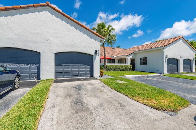 mediterranean / spanish-style house with a garage