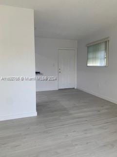 spare room featuring light hardwood / wood-style floors