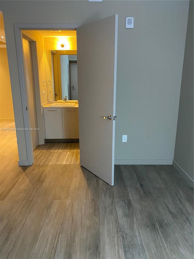 interior space with hardwood / wood-style floors and sink