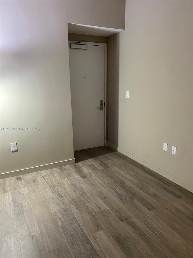 empty room with wood-type flooring