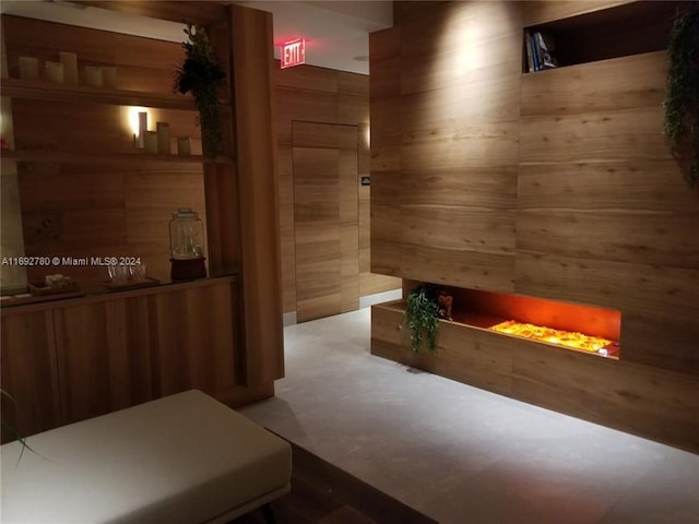 interior space featuring carpet and wooden walls