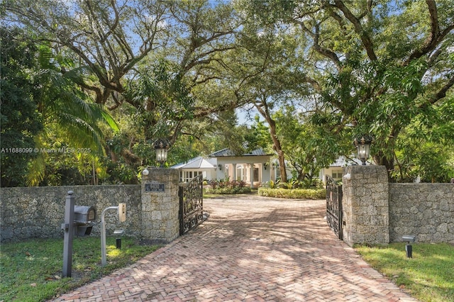 view of gate with a fenced front yard