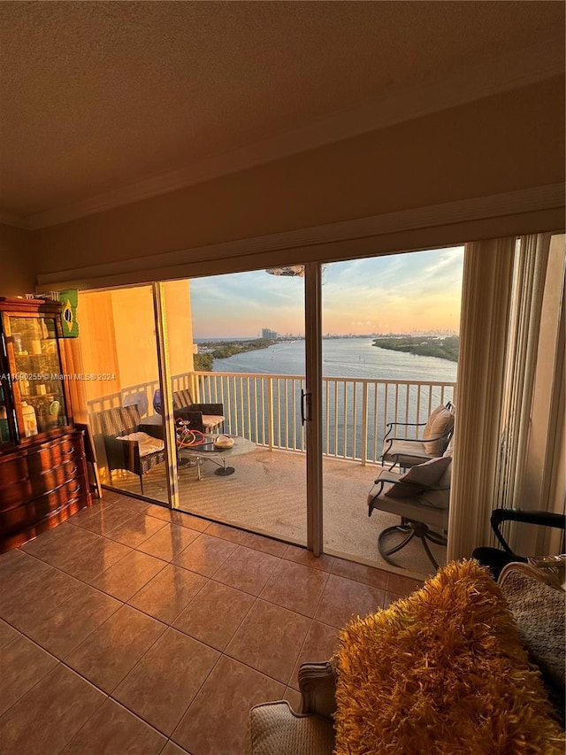 patio terrace at dusk with a balcony and a water view