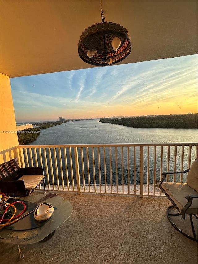 balcony at dusk with a water view