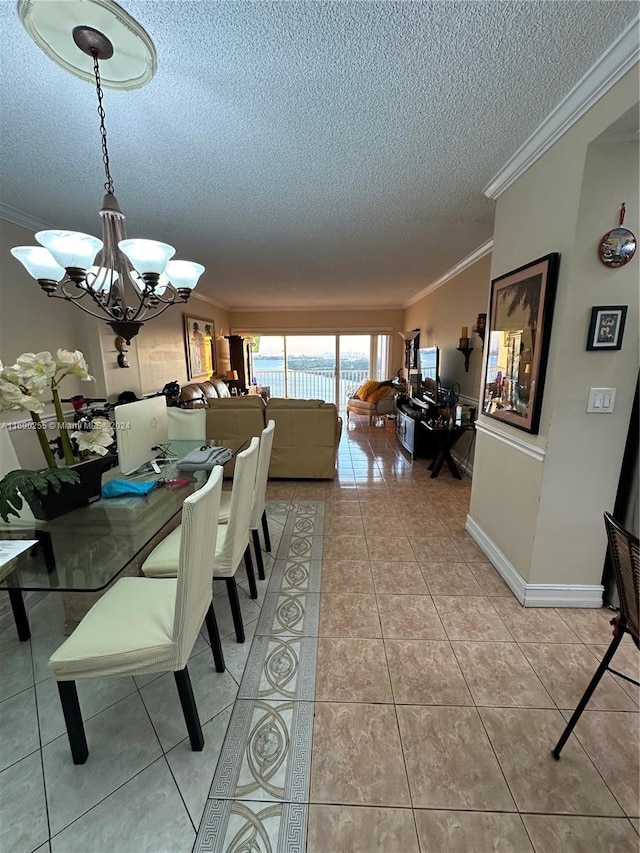 dining space featuring a notable chandelier, ornamental molding, a textured ceiling, and light tile patterned floors