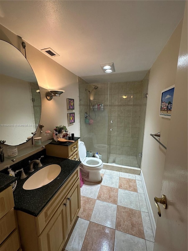 bathroom with toilet, vanity, and walk in shower