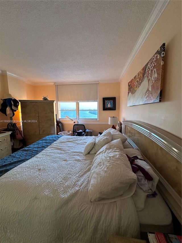 bedroom featuring ornamental molding and a textured ceiling