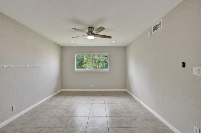 empty room featuring ceiling fan and light tile patterned flooring