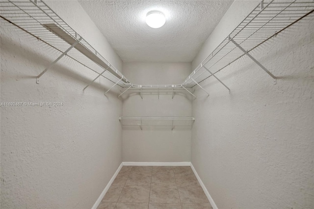 walk in closet with tile patterned flooring