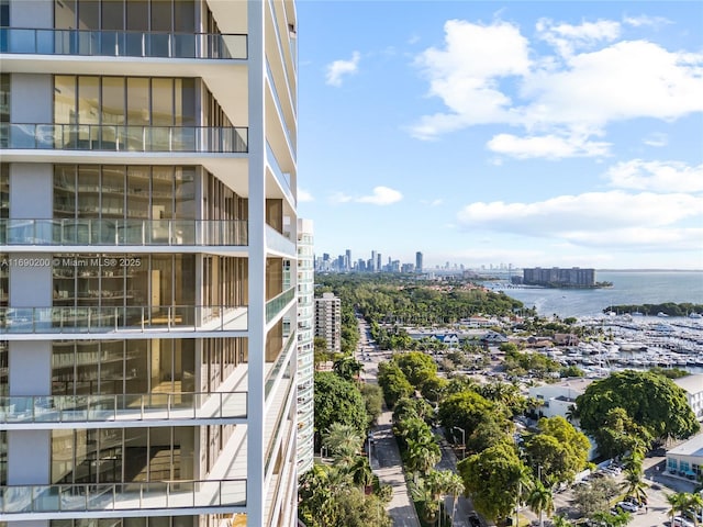 view of building exterior with a city view and a water view