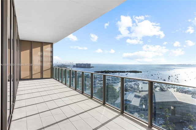 balcony featuring a water view and a beach view