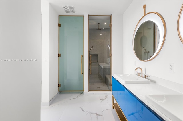 bathroom featuring visible vents, marble finish floor, a sink, a shower stall, and baseboards