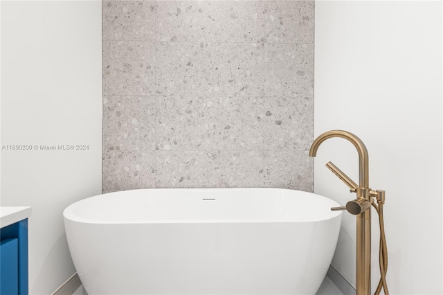 bathroom with vanity and a tub to relax in