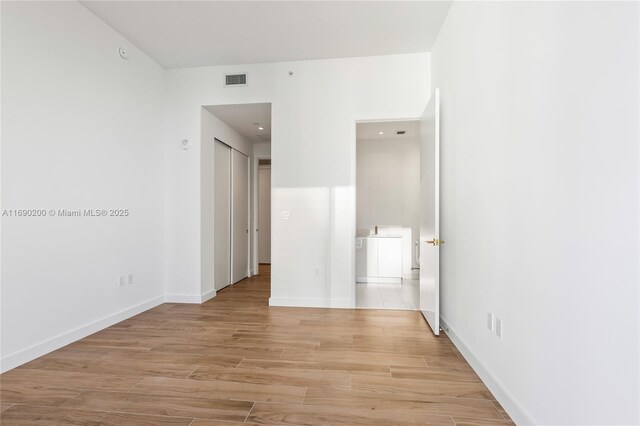 spare room with light wood-type flooring and baseboards