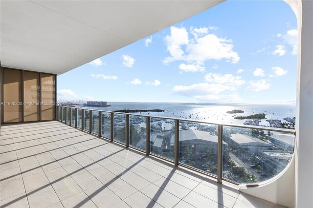 balcony with a water view and a beach view