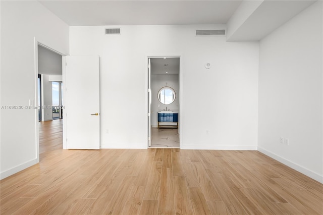 unfurnished room featuring light hardwood / wood-style floors