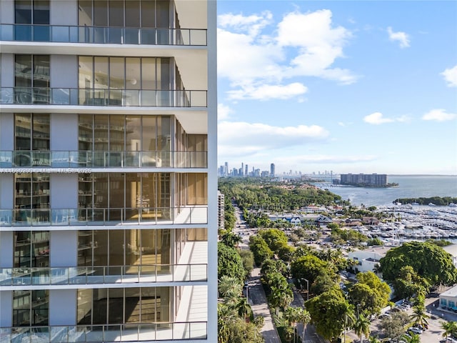 view of building exterior featuring a city view and a water view