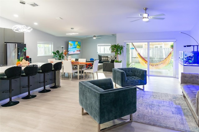 living room with ceiling fan and light hardwood / wood-style flooring