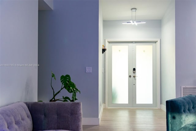 entryway featuring light wood-type flooring and french doors