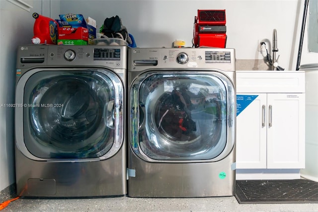 washroom with cabinets and washer and dryer