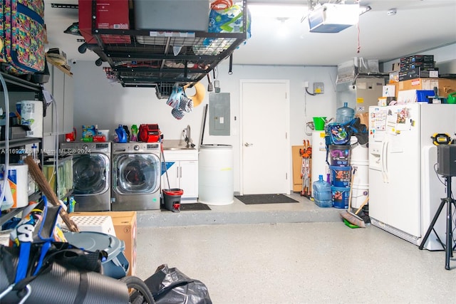 garage with electric panel, sink, a garage door opener, white refrigerator with ice dispenser, and independent washer and dryer