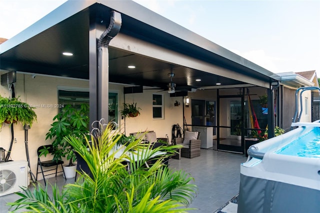 view of patio / terrace with ceiling fan, a pool, and ac unit