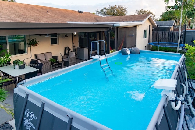 view of swimming pool with an outdoor hangout area and a trampoline