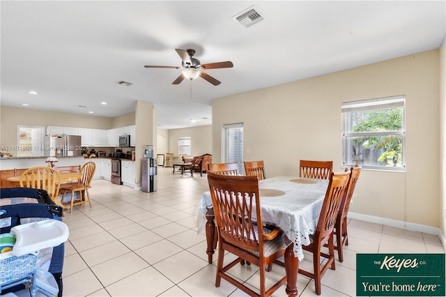 dining room with ceiling fan and light tile patterned flooring