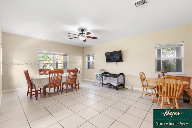 dining area with light tile patterned floors, plenty of natural light, and ceiling fan