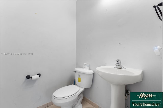 bathroom with tile patterned flooring and toilet