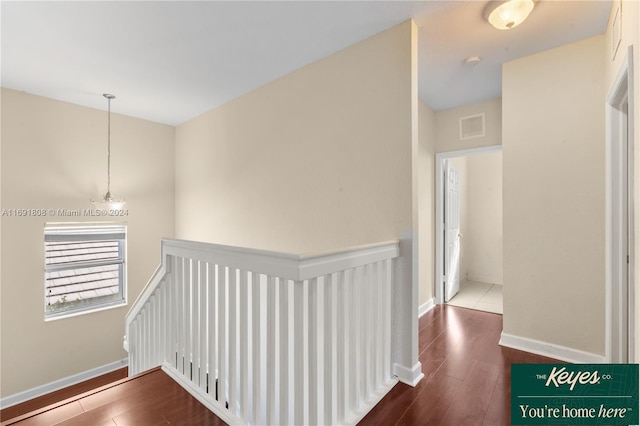 corridor with hardwood / wood-style floors