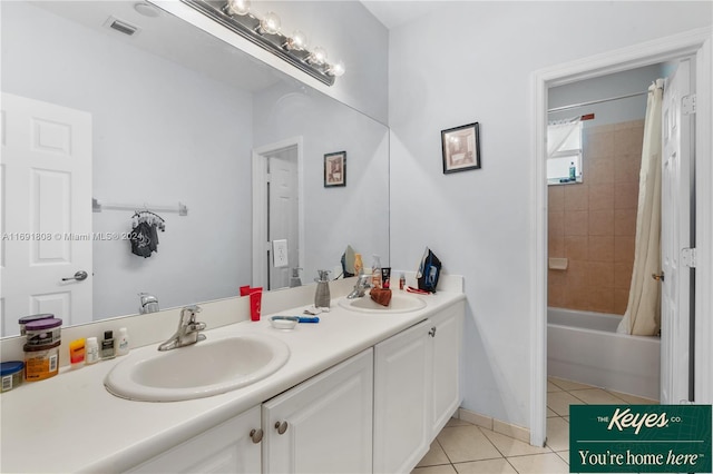 bathroom featuring tile patterned floors, shower / tub combo with curtain, and vanity