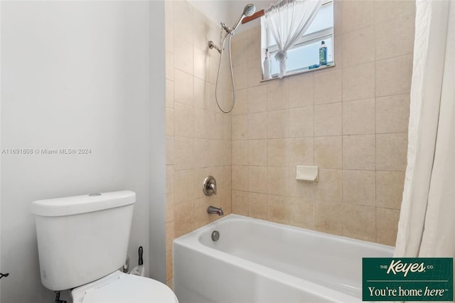 bathroom with shower / bath combo and toilet