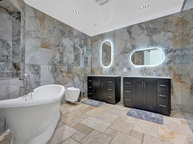 bathroom with vanity, tile walls, and a tub